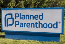 Planned Parenthood sign on a grassy lawn