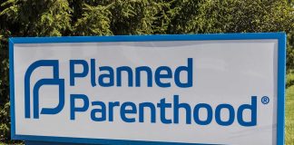 Planned Parenthood sign on a grassy lawn