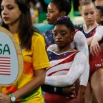 USA gymnasts waiting in line at an event.