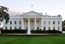 The White House with fountain and American flag