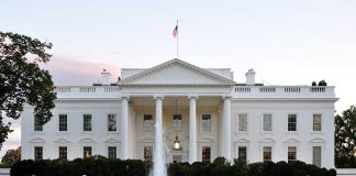 The White House with fountain and American flag