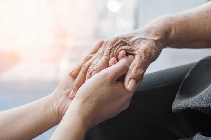 Young hands holding an elderly person's hand