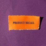 "Product Recall" text on orange paper, purple background.