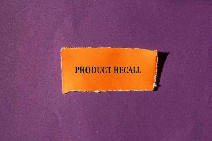 2424448079 "Product Recall" text on orange paper, purple background.