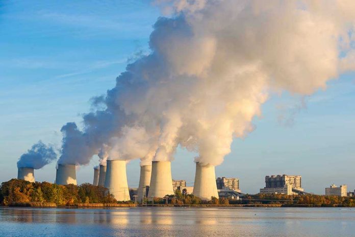 336115076 Nuclear power plant cooling towers emitting steam