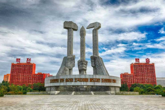 737133424 Concrete monument with hands holding tools under cloudy sky