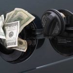 Cash sticking out of a car's gas tank