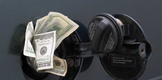 Cash sticking out of a car's gas tank