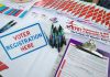 Voter registration table with forms, pens, and brochures.