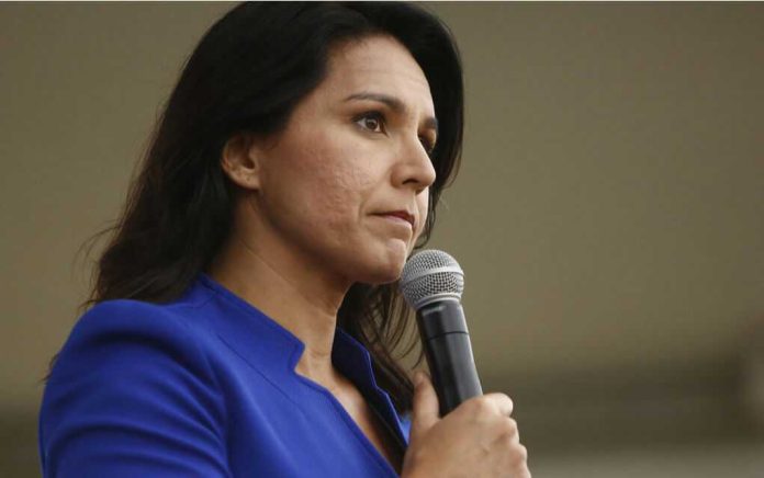 1871750536 Woman in blue blazer holding a microphone.
