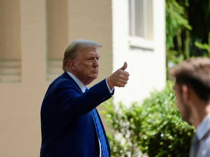 2475761689 Man in suit giving thumbs up.