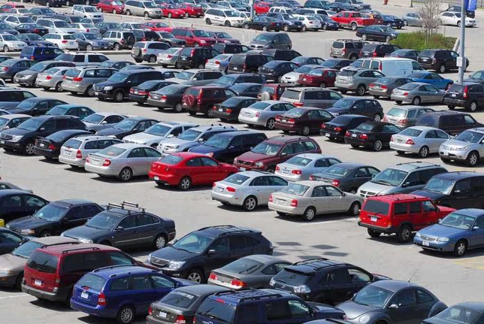 A crowded parking lot filled with various cars