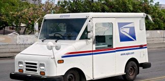 White USPS delivery truck parked on a street
