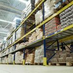 Interior view of a warehouse with stacked shelves of packaged goods