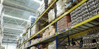 Interior view of a warehouse with stacked shelves of packaged goods