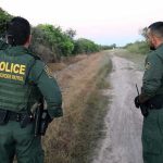 Border Horror: Kids Drugged, Smuggled for Cash Two U.S. Border Patrol officers observing a dirt path.