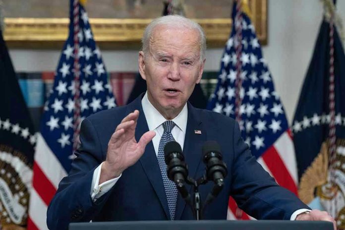 Man speaking at podium with American flags behind.