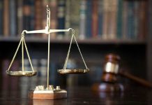 Scales of justice with gavel and books.