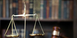 Scales of justice with gavel and books.