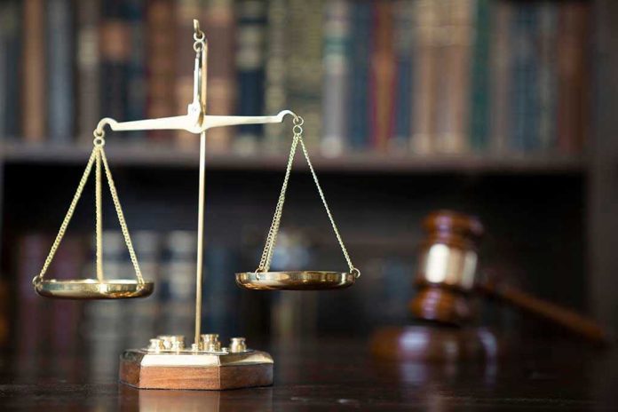 Scales of justice with gavel and books.