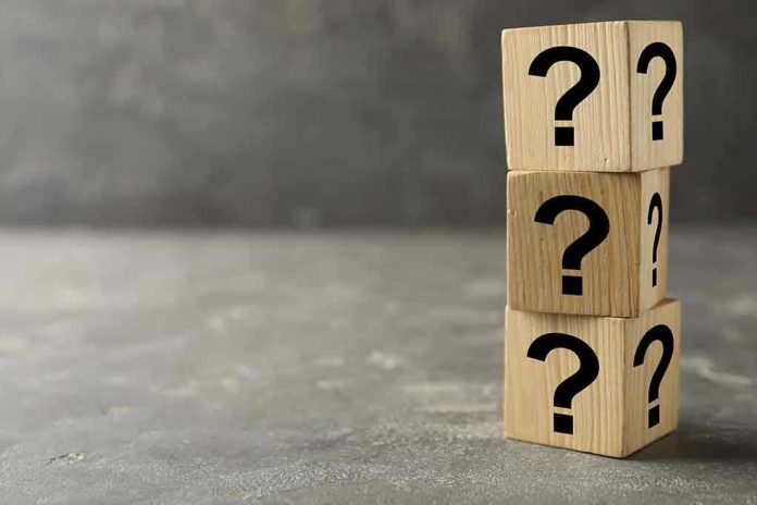 169224694 Three wooden blocks with question marks stacked.