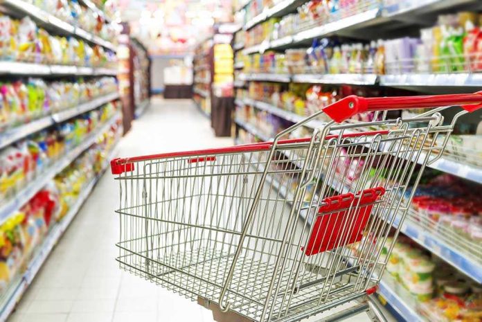 171787895. Empty shopping cart in grocery store aisle.