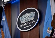 TRUMP’S Pentagon Pick IGNITES Capitol Showdown The Pentagon emblem between two flags.