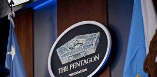 TRUMP’S Pentagon Pick IGNITES Capitol Showdown The Pentagon emblem between two flags.