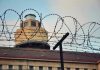 Murder Conviction Rocks NY Prison System Barbed wire in front of a prison tower.