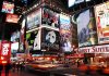 Vibrant night scene of Times Square filled with theater advertisements and neon lights