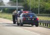 Police officer conducting a traffic stop on a highway