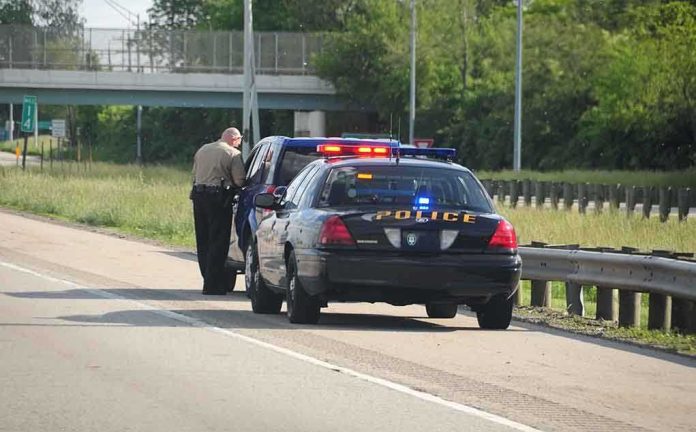 shutterstock_12763549.jpg Police officer conducting a traffic stop on a highway