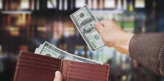 Checkout Line Chaos — Bloodshed in Broad Daylight A hand withdrawing cash from a wallet in a blurred background