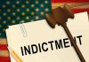 A legal document labeled INDICTMENT with a gavel and pencil