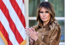 Journalist FORCES Melania Into Epstein Testimony A woman in formal attire clapping in front of an American flag