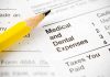 Close-up of tax document with medical and dental expenses section and a yellow pencil