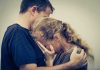 A couple embracing, with one partner comforting the other who is in distress