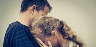 Emotional Reunion — Reunited Couple Free At Last A couple embracing, with one partner comforting the other who is in distress