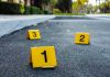Texas Rampage: Man Kills 3, Crashes Into Store Crime scene markers on asphalt with bullet casing.
