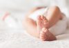 HORRIFYING Workplace Discovery — Baby Found Dead Close-up of baby feet lying on blanket.