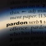 MAGA Heroes Freed — Massive Legal Shake-Up The word pardon highlighted in a dictionary.
