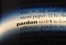The word pardon highlighted in a dictionary.