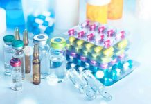 Vials and blister packs of pills on table