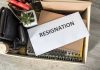 TRUMP’S $1B Lawsuit – TOP Leadership RESIGNS Envelope labeled resignation in a box of office items.