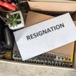 TRUMP’S $1B Lawsuit – TOP Leadership RESIGNS Envelope labeled resignation in a box of office items.