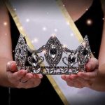 Miss Universe Owner VANISHES Before Fraud Verdict Sash-wearing person holding an ornate jeweled crown.