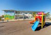 Mother Pushes Dead Child 44 Hours: System Fails Colorful playground slide in front of a building.