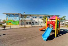 Mother Pushes Dead Child 44 Hours: System Fails Colorful playground slide in front of a building.