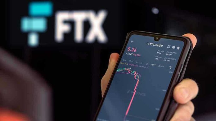 Hand holding phone with FTX trading app.