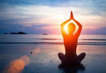 Scientific Shock: Consciousness May Outlive Death Person meditating on the beach during sunset